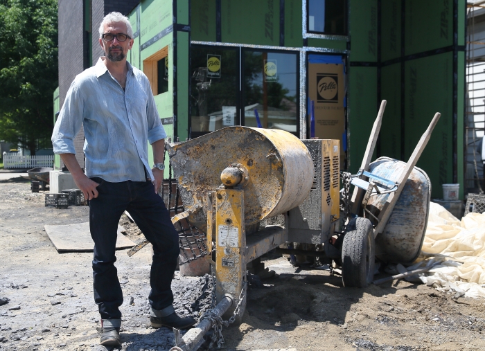 homeowner standing in front of his home under contruction